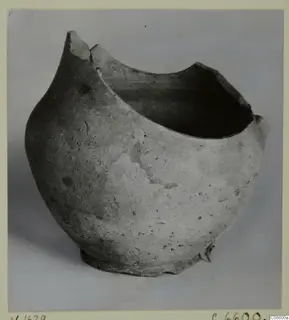Pottery Plain White VII jug, broken at the rim, photographed in side view against a grey backdrop.