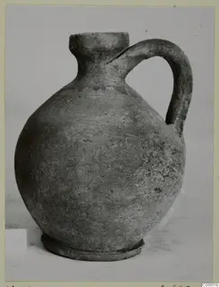 Pottery Plain White VII jug from Vouni, a round-bodied jug with a single handle and a narrow neck.