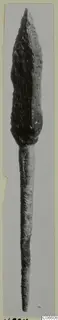 Bronze arrowhead from Vouni, photographed upright against a grey background