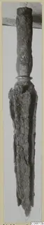 Corroded iron weapon butt-spike from Vouni, shown upright on a mounted card