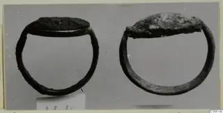 Two silver rings with flat oval tops, photographed side by side on a grey background, from Vouni