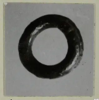 Silver ring-shaped find from the Korakas tombs at Vouni, photographed face-on