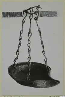 Lamp from Vouni T. 1-16 hanging on three chains from a hook, shown against a pale background.