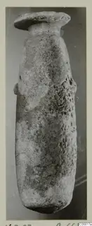 Alabaster vessel from Vouni, with a flat disc-shaped rim on a short neck and a rounded body.