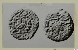 Two round objects with raised, irregular marks on their faces, from Vouni