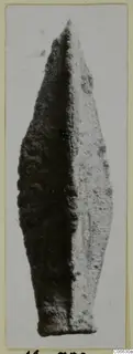 Leaf-shaped metal arrowhead from Mersinaki, shown upright on a pale card mount