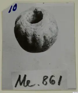 Rounded bead with a large hole at the top, photographed on a card with a handwritten number label
