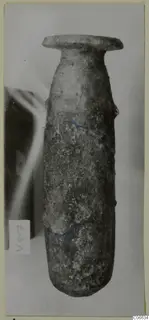 Alabaster alabastron from Cyprus: a tall, narrow stone vessel with a flared rim, photographed upright against a pale background