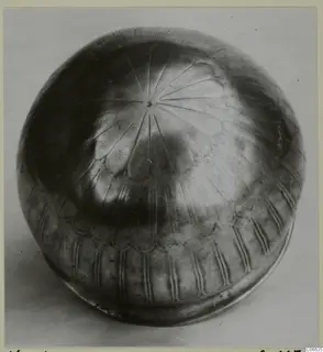Silver rounded vessel from Vouni with incised radiating lines on its top and vertical grooves around the base