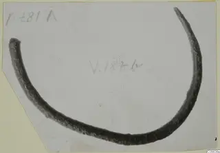 Open bronze bracelet, a single curved bar with tapering ends, mounted on a card with handwritten labels