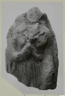 Fragmentary terracotta figurine of a standing figure with a bent arm and vertical drapery folds
