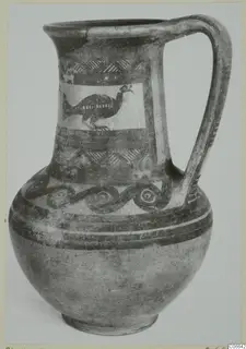 Painted jug with a single handle, a bird in a panel on the neck and spiral bands on the shoulder