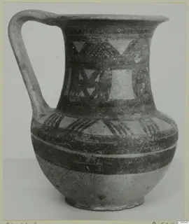 Pottery jug with a single strap handle, flaring mouth and painted triangles and bands, Bichrome Wheel-made