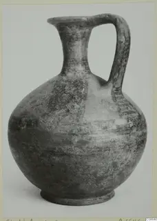Jug with a single strap handle and flaring neck, shown alone against a pale background