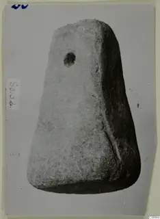 Trapezoidal worked object with a round hole near its top, from Soli