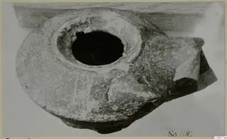Terracotta lamp with a large round filling hole, photographed from above at an angle.