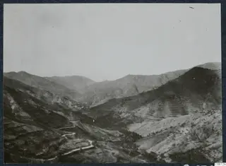 Landscape view of a valley with terraced hillsides and a winding road, at Lapithos