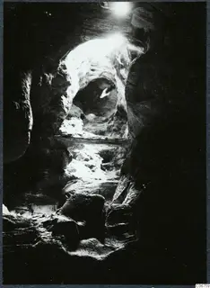 Interior of a rock cave at Kythrea, looking toward a bright opening in the rock.