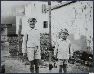 Martin and Stefan Gjerstad standing beside a metal standpipe in a yard in Nicosia