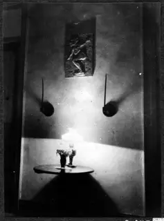 Hall of a house in Nicosia with a carved relief panel on the wall and a lamp on a round table