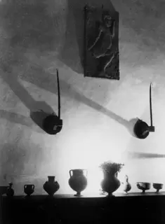 Hall of a house in Nicosia with a row of vessels on a shelf and a relief plaque on the wall