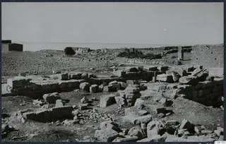 Ruined stone walls of the Temple of Aphrodite, with the sea on the horizon