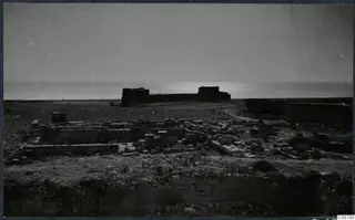 Ruins of the Temple of Aphrodite at Kouklia, with stone walls and foundations and the sea beyond