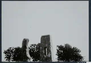Two tall weathered stone monoliths with tree canopies behind them, at Palaipaphos near Kouklia