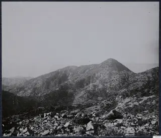 Mountain peak above a stony hillside with scrub, at Troodos Machairas