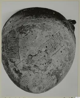 Pottery vessel from the Vrysi tou Barba tombs at Lapithos, with grooved and incised decoration on its body.
