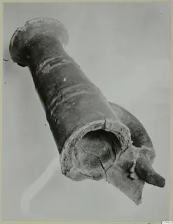 Broken Red Polished II jug from the Vrysi tou Barba tombs at Lapithos, photographed at an angle