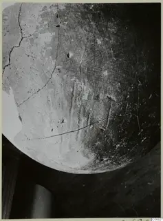 Close view of the rounded body of a Red Polished II jug from Lapithos, its surface cracked and worn.