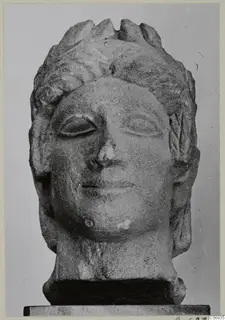 Limestone head of a figure from Mersinaki, with wavy hair and a slight smile, shown frontally