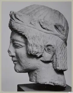 Limestone head from Mersinaki, shown in profile facing left on a dark square base