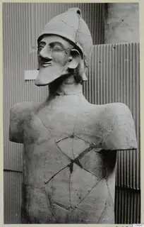Terracotta statue of a helmeted figure, upper body, with cracks and repairs across the chest and neck