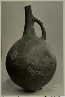 Red Polished I pottery vessel with a single loop handle and tall narrow neck, from the Lapithos tombs