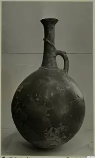 Pottery Red Polished II jug from Lapithos, with a globular body, long neck and loop handle