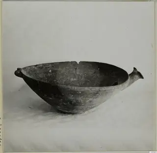 Red Polished III bowl with two small handles, photographed on a draped cloth