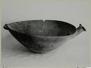 Red Polished bowl with a small handle at each side, photographed on a light background