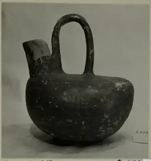 Red Polished III jug from Lapithos, with a tall loop handle and a short side spout