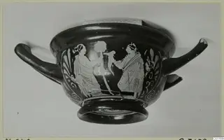Red figured skyphos, a two-handled cup, with painted draped figures between palmette ornaments