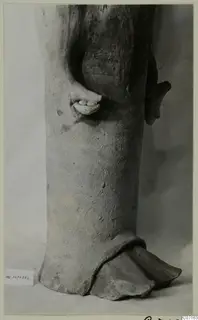 Terracotta statue, lower body with a hand against its side and a broken base, from Mersinaki