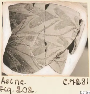 Painted pottery sherd from Asine, two joined fragments with dark curving motifs, on a card mount