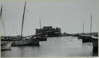 Paphos Castle at the western end of the city port, with moored sailing boats in the foreground
