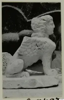 Carved white stone statue of a winged creature with a human head and lion-like body, from Soli