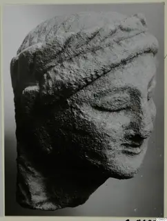 Limestone head from Kition with lowered eyes and a banded headdress