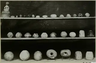 Three shelves of pottery vessels, several with painted patterns, and a small figure, from Cyprus, Cyprus Museum