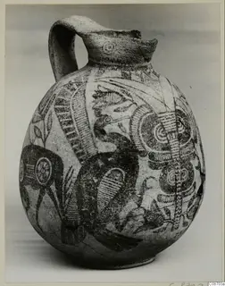 Bichrome IV jug with a single handle, its pale body painted in dark with a large bird-like motif and spirals