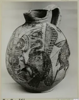 Pottery Bichrome IV jug with a strap handle, painted with a large bird and geometric patterns, shown against a grey backdrop.