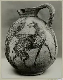 Painted jug with a strap handle, decorated with a long-legged animal and rosette motifs